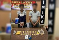 Kedua pelaku beserta barang bukti diamankan di Kantor Polres Mimika, Mile 32, Jalan Agimuga, Timika, Papua Tengah. (Foto: Istimewa)