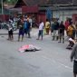 Tampak pria lansia yang tergeletak di tengah jalan dan ditutup menggunakan tikar. (Foto: Galeri Papua/Wahyu)