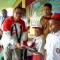 Penjabat Bupati Mappi Dr. Michael Gomar secara pribadi menyerahkan bantuan pakaian seragam serta sepatu bagi anak-anak Sekolah Dasar Negeri Nohon. (Foto: Istimewa/Humas Pemda Mappi)