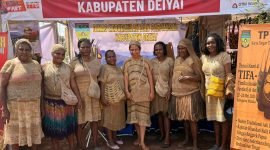 Peserta dari Kabupaten Deiyai sedang berfoto di depan stan dengan mengenakan busana adat. (Foto: Istimewa)