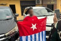 Pria berinisial A diamankan di Jalan Baru, Mimika Papua Tengah, Senin (1/12/2025). Ia dimintai keterangan terkait asal baju corak bintang kejora yang dikenakan. (Foto: Istimewa)