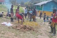 Kepala Suku Besar Kabupaten Puncak, Yohan Dewelek, menggelar tradisi bakar batu bersama masyarakat di Kampung Kimak, Distrik Ilaga, Kabupaten Puncak, Senin (16/12/2025). (Foto: Istimewa)