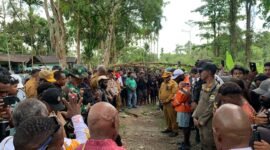 Para pejabat dari Pemkab Mimika, Pemkab Puncak, Forkopimda, dan masyarakat dari dua kubu berkonflik, sedang hening dalam doa usai ritual patah panah untuk mengakhiri konflik Kwamki Narama, Senin (12/1/2026). (Foto: Galeri Papua/Ahmad)