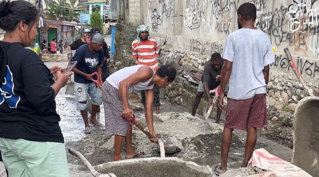 Warga belakang Bengkel Surabaya Motor, Jalan Ahmad Yani, Kelurahan Kebun Sirih, Distrik Mimika Baru, Kabupaten Mimika, Papua Tengah, bergotong royong melakukan penanganan awal perbaikan drainase, Selasa (21/4/2026). (Foto: Galeri Papua/Endy Langobelen)