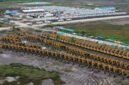 PSN - Ratusan alat berat ekskavator berjejer di Kampung Wanam, Distrik Ilwayab, Merauke, Papua Selatan, Senin, 8 Desember 2025. Alat berat ini untuk mendukung proyek strategis nasional lumbung pangan dan energi yang menjadi sorotan dalam film dokumenter Pesta Babi. Galeripapua/ Pusaka Bentala Rakyat.